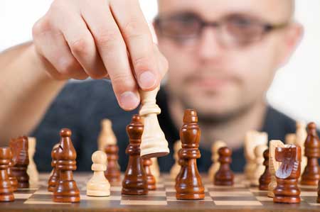 man analyzing a chess game